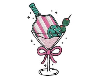 May include: A pink martini glass with a striped bottle inside and green olives on a stick. The glass has a pink bow on the stem.