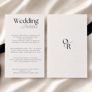 May include: Two white rectangular wedding detail cards with black text. The left card features the heading Wedding Details followed by accommodation and event information. The right card displays a black monogram with the letters O and R.