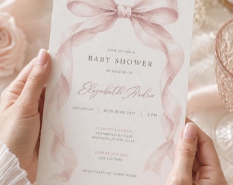 May include: A rectangular baby shower invitation card featuring a watercolor illustration of a dusty pink ribbon tied in a bow at the top. The text reads: JOIN US FOR A BABY SHOWER IN HONOR OF Elizabeth Arden SATURDAY 16TH JUNE 2027 2 PM.
