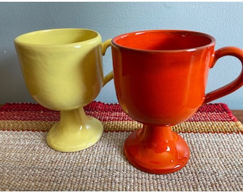 Two Mid Century Mugs, Coffee & Tea, Pedestal Base With Handles, Orange and Yellow