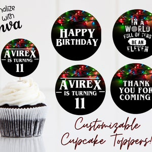 May include: Four round cupcake toppers with a black background and colourful Christmas lights. The toppers feature text that says "Happy Birthday", "Avrex is turning 11", "In a world full of tens be an eleven", and "Thank you for coming".