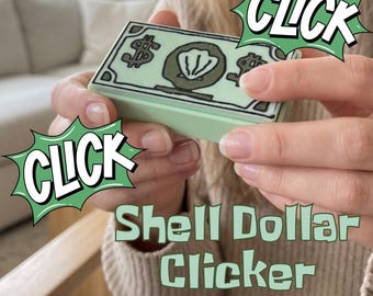 Puede incluir: Un dispositivo de clic rectangular de color verde claro con un dibujo lineal negro de un billete de dólar con un icono de concha central. La palabra CLICK aparece en burbujas verdes y el texto Shell Dollar Clicker está impreso en verde.
