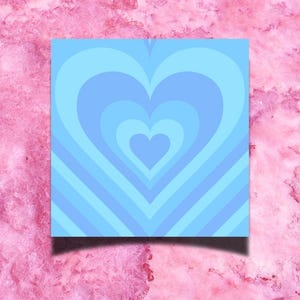 May include: A blue and white heart-shaped design with concentric circles. The design is on a light blue background.