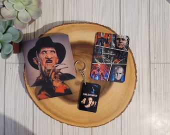 May include: A set of horror movie themed merchandise featuring Freddy Krueger from the Nightmare on Elm Street franchise, Jason Voorhees from the Friday the 13th franchise, and characters from the Final Destination franchise. The set includes a can cooler, a keychain, and a key chain charm.