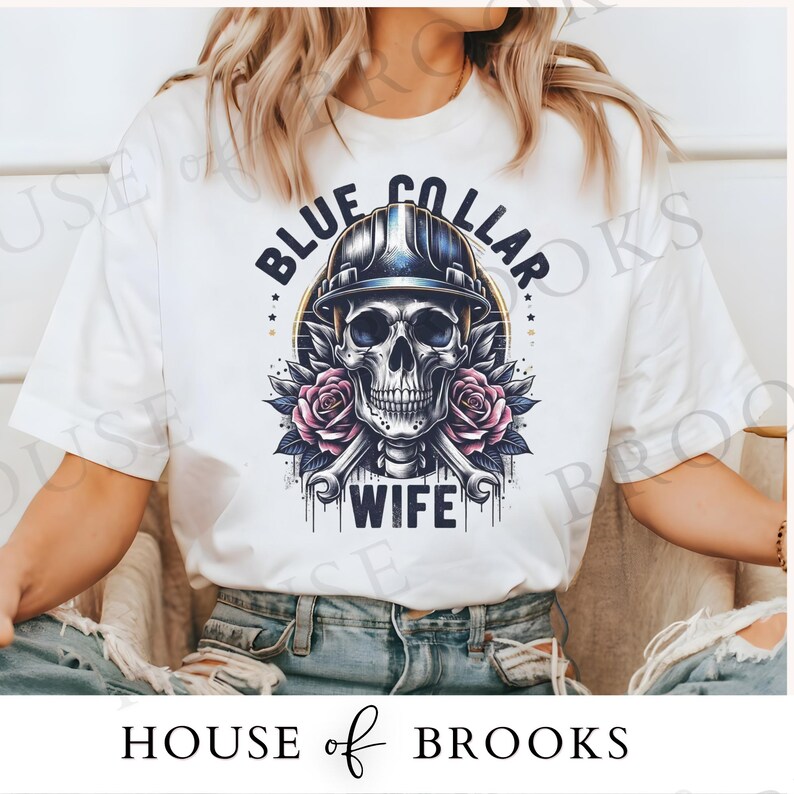 May include: White t-shirt with a blue collar skull graphic and the text "Blue Collar Wife".