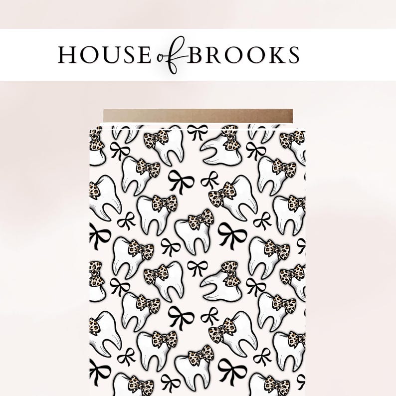 May include: Card with a repeating pattern of cartoon teeth wearing leopard print bows and black bows on a light pink background. The text "HOUSE of BROOKS" is at the top in black.