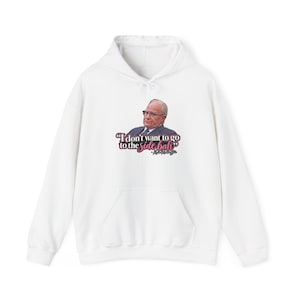 May include: A white hooded sweatshirt featuring a graphic of a person in a suit and glasses. Below the image, the text reads: "I don't want to go to the side bah" in black and pink lettering, followed by the signature "- Kevin O'Leary".
