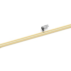May include: Gold barbell with two ball ends. The barbell is approximately 3/8 inch in diameter and 1 1/2 inches long.