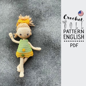 May include: Crochet doll pattern in English, PDF format. The doll is wearing a green and yellow dress with buttons. The doll has blonde hair and a smiling face.