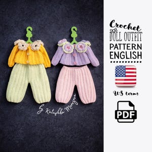 May include: Two crochet doll outfits, one yellow and green, the other purple and pink, each with a matching top and pants. The tops have floral accents and are hanging on green hangers. The image includes text that says "Crochet Doll Outfit Pattern English".