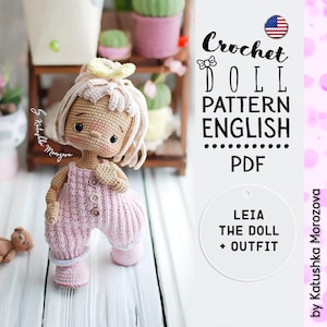 May include: Crochet doll pattern in English, PDF format. The pattern is for a doll named Leia, and includes an outfit. The doll is pink and white, with a flower on her head.
