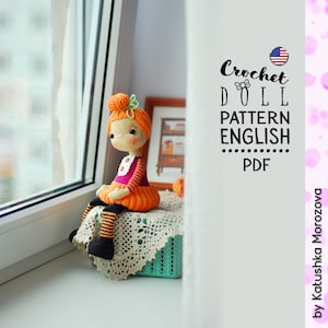 May include: Crochet doll pattern in English, PDF format. The pattern features a doll with orange hair, a pink and white dress, and black and orange striped legs. The doll is sitting on a white crocheted doily in a green basket.