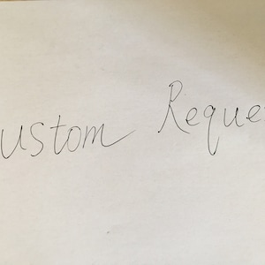 May include: Handwritten note on white paper that says "Custom Request".