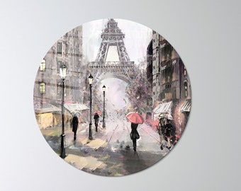 May include: A circular painting depicting a Parisian street scene with the Eiffel Tower in the background. The street is lined with lampposts and buildings, and people are walking along the sidewalk. Some people are carrying umbrellas, and the sky is a soft gray color.