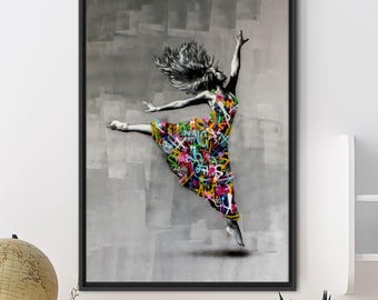 May include: Framed art print featuring a dancer in mid-air. The dancer's dress is covered in colorful graffiti against a gray background. The artwork is framed in a black border and is displayed on a white wall.