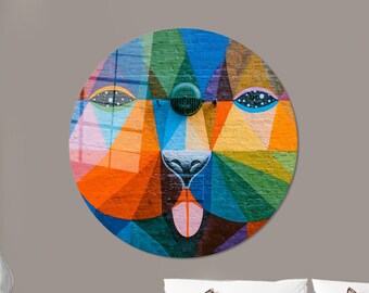 May include: A colorful abstract mural of a face with geometric shapes in shades of blue, green, orange, pink, yellow, and purple. The face has a large, pink tongue sticking out.