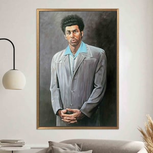 May include: A framed portrait of a man in a gray suit with a light blue shirt. The painting has a dark background and is in a gold-colored frame. The man has dark, curly hair and is looking directly at the viewer.