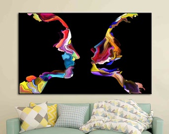 May include: Abstract painting of two colorful faces facing each other on a black background. The faces are made up of swirling shapes and colors, including red, blue, green, yellow, and purple.