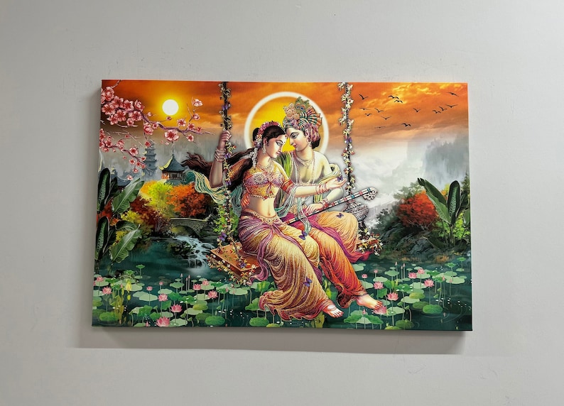May include: A colorful painting depicting a couple on a swing in a lush garden setting. The woman is wearing a yellow and red sari, while the man is wearing a blue and gold outfit. The background features a waterfall, flowers, and trees.