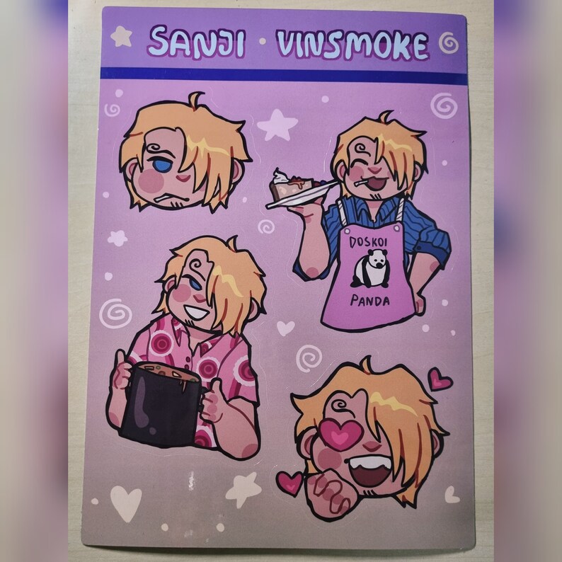 May include: Four stickers featuring different illustrations of a blonde-haired character with a pink background. The character is shown with different expressions and in different poses. The text "SANJI VINSMOKE" is at the top of the sticker sheet. One sticker shows the character wearing a pink apron with the text "DOSKOI PANDA".
