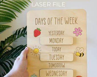 May include: A wooden board with the words "Days of the Week" written on it. The board has five sliding pieces with the days of the week written on them. Each piece has a small illustration next to it. The illustrations are a strawberry, a sun, a flower, a bee, and a rainbow.