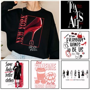 May include: Black sweatshirt with a red graphic of a high-heeled shoe, the words "NEW YORK" and "THE DEVIL WEARS PRADA." Other images show fashion illustrations with text including "Everybody Wants to Be Us" and "Same Andy, better clothes."
