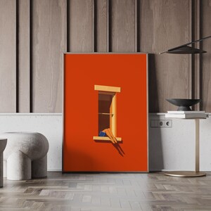 May include: A framed art print featuring a minimalist illustration. The artwork depicts a person relaxing in a window, with legs and feet visible. The background is a vibrant orange, with a wooden window frame. The artwork is displayed on a wall.