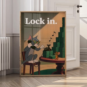 Puede incluir: Impresión enmarcada de dibujos animados con Tom el gato con gafas de sol hablando por teléfono y Jerry el ratón. El texto "Lock in." está en la parte superior. También hay montones de dinero y notas musicales en la imagen.