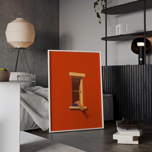 May include: A framed art print featuring a minimalist illustration. The artwork depicts a window set in a vibrant orange wall. Legs in blue shorts are visible in the window. The print is in a white frame.