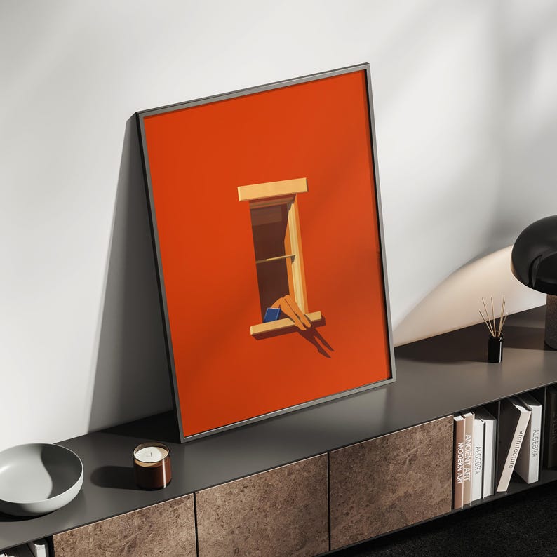 May include: Framed art print featuring a vibrant orange background with a window illustration. The window depicts a person relaxing, legs dangling out. The artwork is displayed on a dark gray cabinet, adding a modern touch to the room.