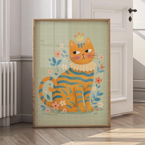 May include: A framed art print featuring a whimsical orange cat with blue stripes, wearing a crown and ruffled collar. The cat is surrounded by flowers on a light green grid background. The artwork is in a wooden frame.