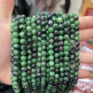 May include: A rustic wooden sign with the text "Welcome to our home" in white lettering. The sign features a distressed finish and a simple, inviting design, perfect for front door decor.