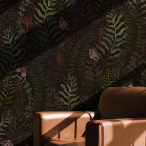 May include: A brown leather armchair with a dark green floral wallpaper featuring butterflies and leaves. The wallpaper has a subtle textured pattern.
