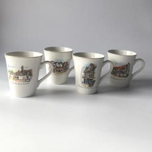 May include: A set of three ceramic mugs with a speckled, matte finish. The mugs are in shades of cream, light gray, and dark gray. Each mug has a simple, minimalist design, perfect for coffee or tea.