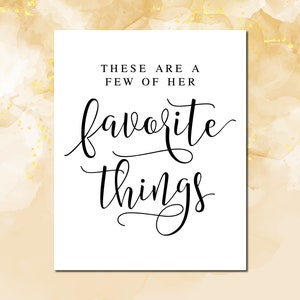 May include: A white sign with black text that reads "These are a few of her favorite things".