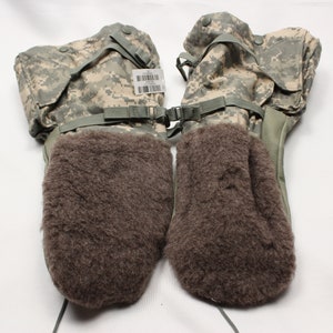May include: A pair of brown fleece lined camouflage mittens with a strap and buckle closure.