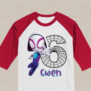 May include: White and red raglan-sleeve shirt with a cartoon Spider-Gwen character. The number 6 is designed with a spiderweb pattern, and the name "Gwen" is written in colourful letters. The shirt is a children's birthday theme.