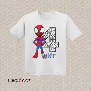 May include: White t-shirt with a red and blue cartoon Spiderman character, a black number 4 with a spiderweb design, and the name "Tyler" in blue text.