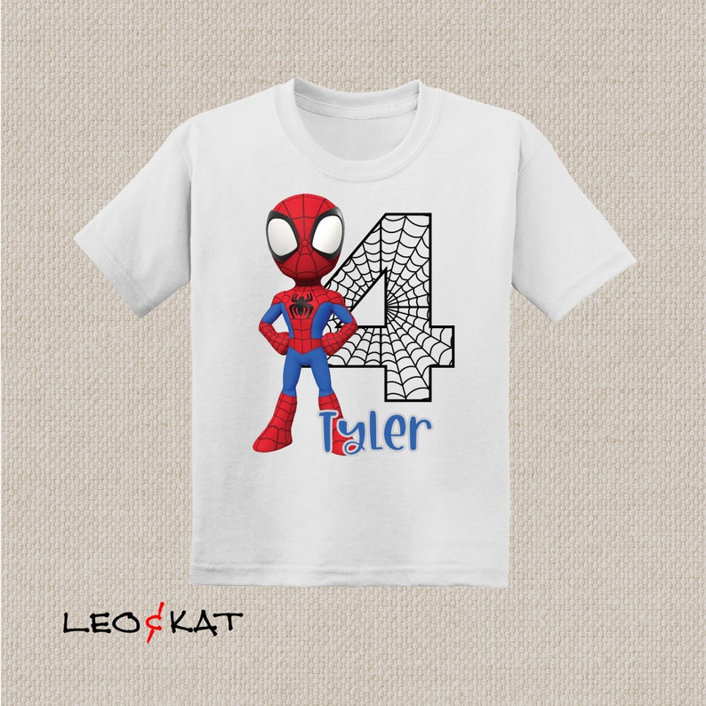 May include: White t-shirt with a red and blue cartoon Spiderman character, a black number 4 with a spiderweb design, and the name "Tyler" in blue text.