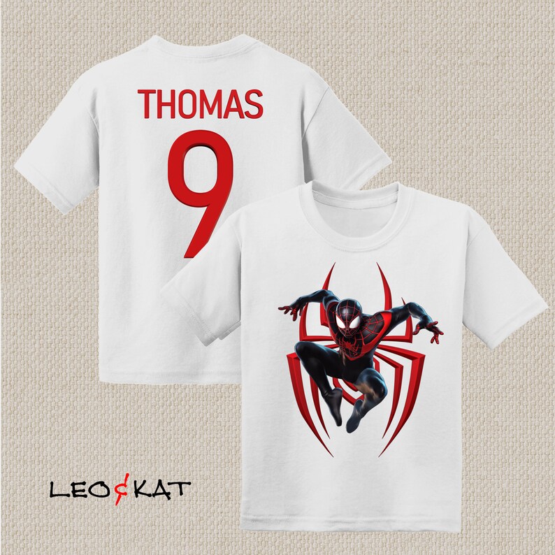 May include: White t-shirt with a red number 9 and the name "THOMAS" printed on the back. The front of the shirt features a graphic of Miles Morales, the Spider-Man character, in his black and red suit.