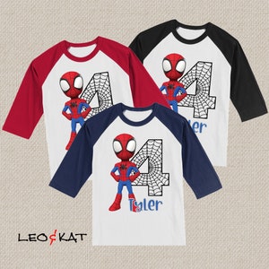 May include: Three baseball style shirts with a red and blue Spiderman design. The shirts are white with a red or blue sleeve. The number 4 is on the shirt with a spider web design. The name Tyler is on the bottom of the shirt.