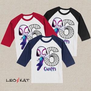 May include: Three baseball-style shirts with white bodies and coloured sleeves: red, black, and navy blue. Each shirt features a cartoon character, a large number 6, a spiderweb design, and the name "Gwen". The shirts are from the brand "LEO & KAT".