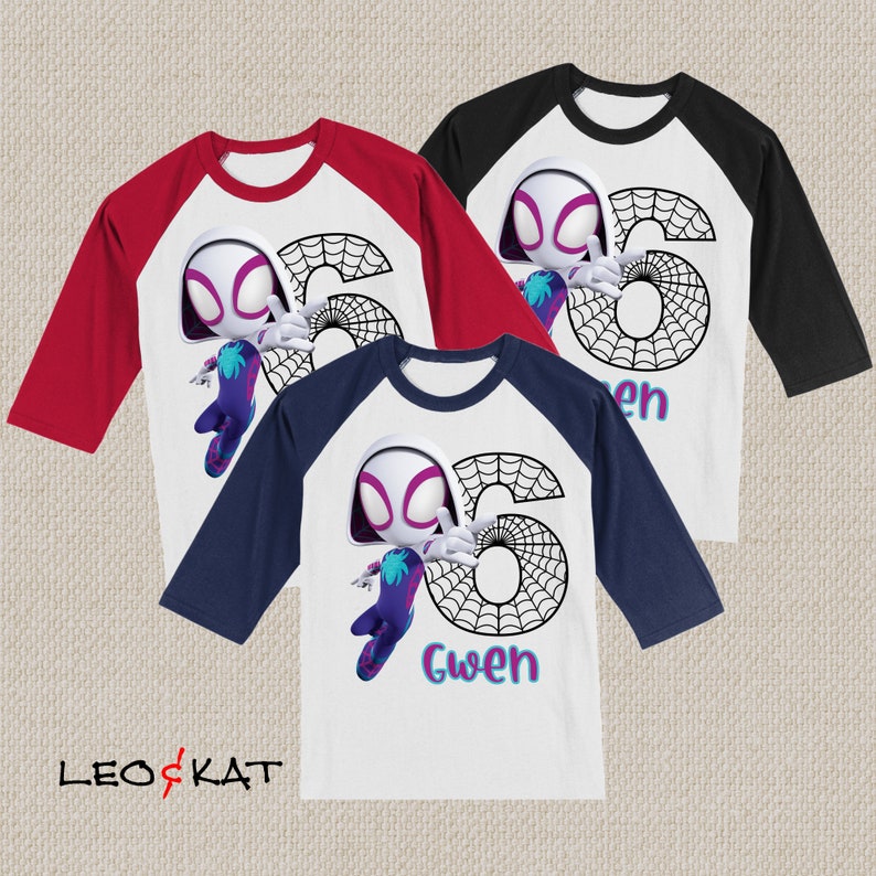 May include: Three baseball-style shirts with white bodies and coloured sleeves: red, black, and navy blue. Each shirt features a cartoon character, a large number 6, a spiderweb design, and the name "Gwen". The shirts are from the brand "LEO & KAT".