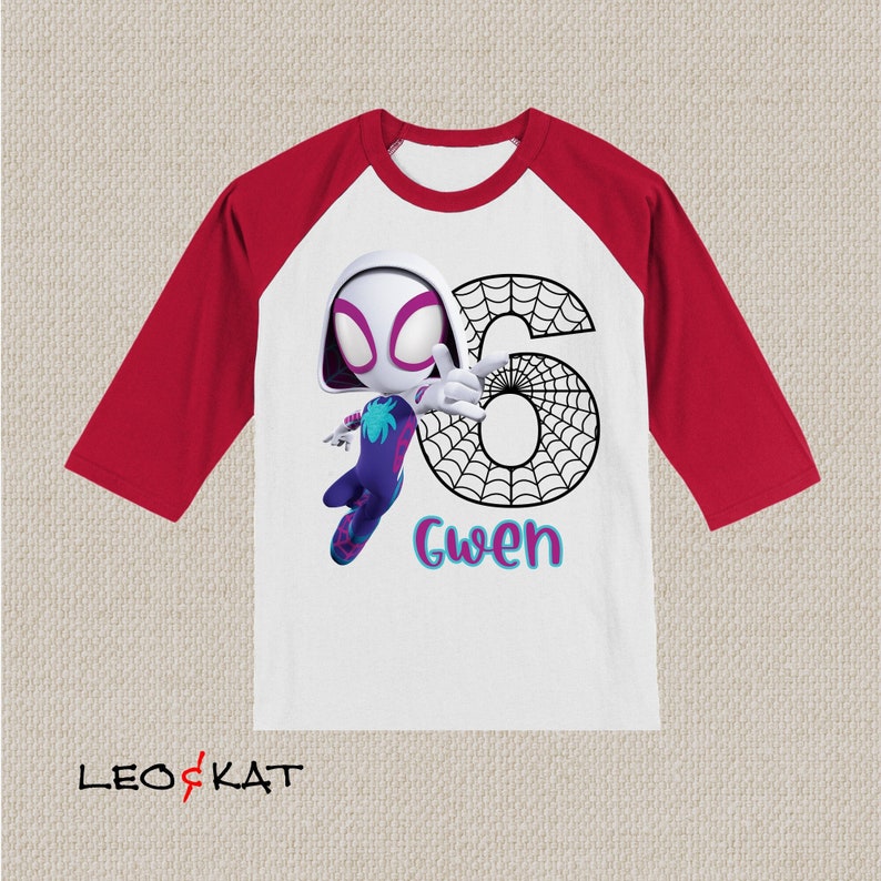 May include: White and red raglan-sleeve shirt with a cartoon Spider-Gwen character. The number 6 is designed with a spiderweb pattern, and the name "Gwen" is written in colourful letters. The shirt is a children's birthday theme.