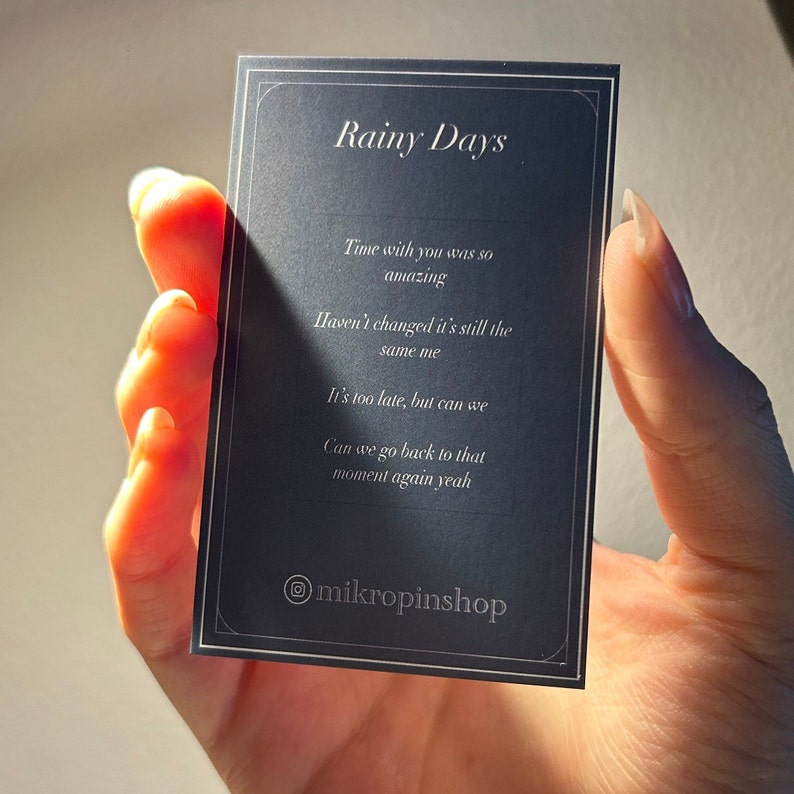 Backing card for the pin features lyrics from a verse in Rainy Days by V as seen on his solo album Layover.