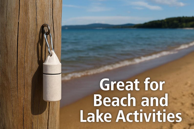 May include: A cylindrical, off-white, matte-finish waterproof container with a black O-ring seal, attached to a silver metal carabiner. The text "Great for Beach and Lake Activities" is displayed in white font on the right side of the image.