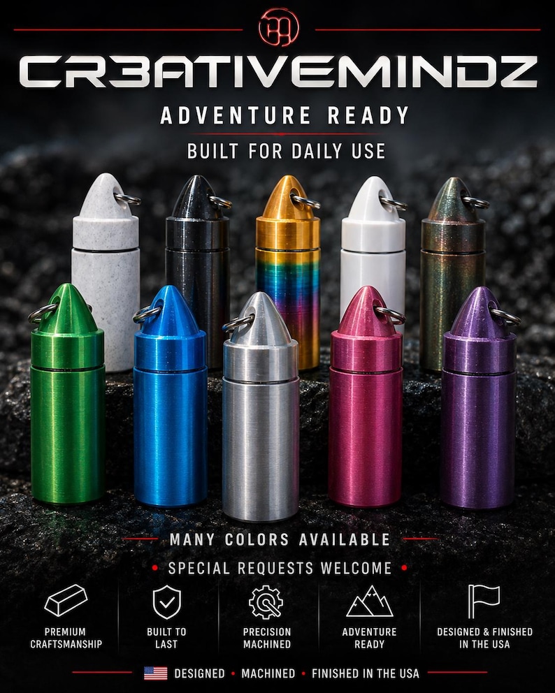 May include: A collection of ten cylindrical metal pill fobs with bullet-shaped caps and key rings, displayed in various colors including green, blue, silver, pink, purple, white, black, gold, and iridescent. Text reads CR3ATIVEMINDZ ADVENTURE READY.