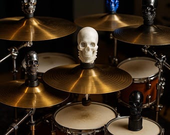 May include: A drum kit with brass cymbals and wooden drums. Each cymbal is topped with a decorative skull in various colors, including silver, white, blue, and black. The drum set is set against a dark background.