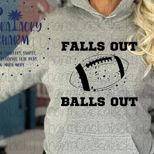 May include: A grey hoodie with the text "FALLS OUT" and "BALLS OUT" in black lettering. A black and white illustration of a football is above the text.