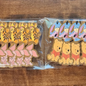 May include: Two bags of colorful cartoon character stickers. One bag has 12 Winnie the Pooh and Piglet stickers. The other bag has 12 Eeyore stickers.